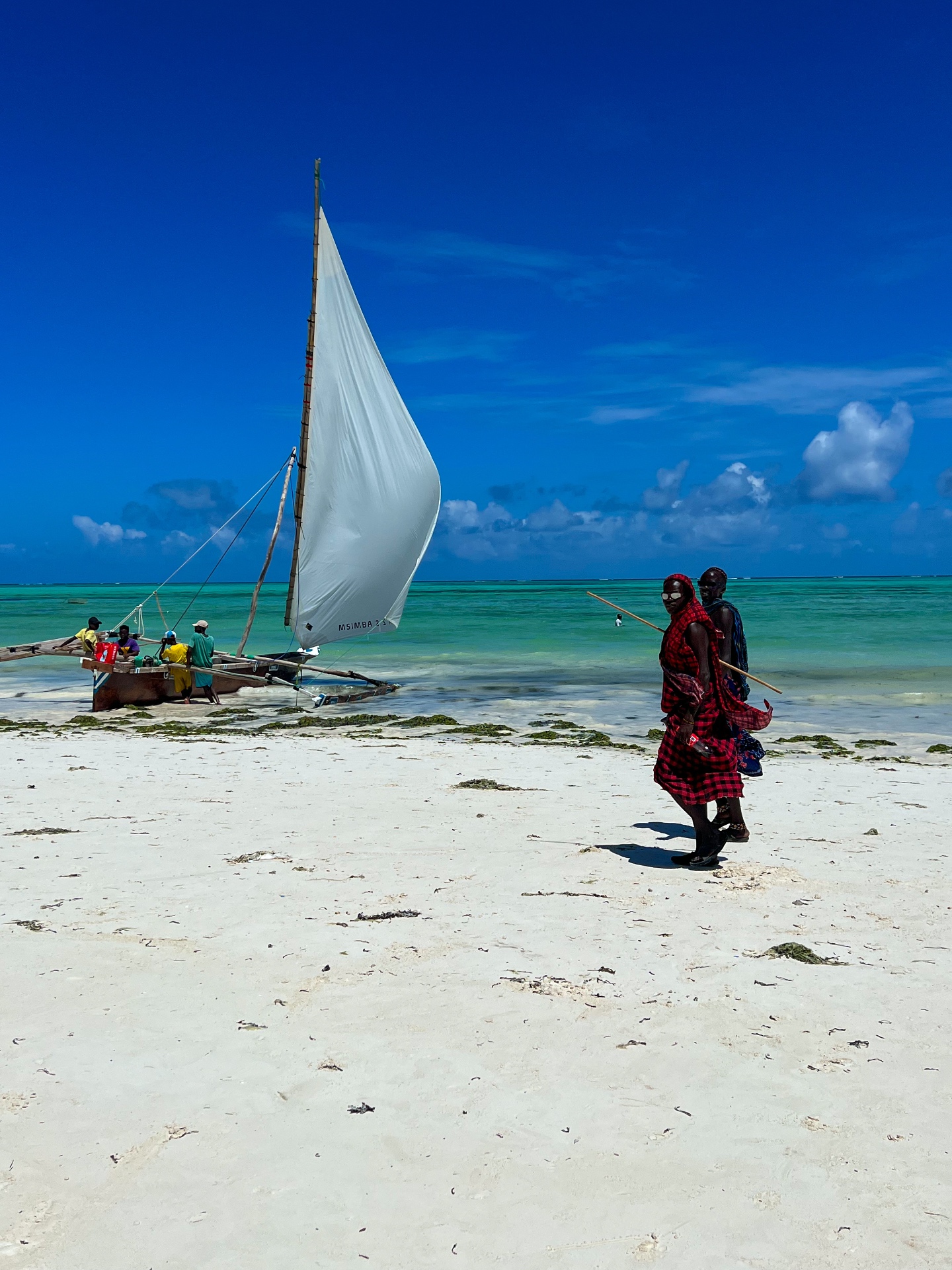 Maasai walking a Zanzibar beach